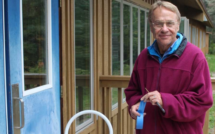 A person uses blue tape during a service project with Outward Bound.
